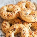 Fresh baked 2 ingredient keto bagels with everything seasoning on linen kitchen towel